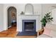 Elegant fireplace design creates a focal point in a sunlit living room with hardwood floors at 2504 State St, Durham, NC 27704