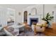 Bright living room featuring hardwood floors, fireplace and arched doorways enhancing the home's layout at 2504 State St, Durham, NC 27704