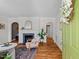 Bright living room with hardwood floors, fireplace, and arched doorways, showcasing classic charm at 2504 State St, Durham, NC 27704