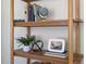 Wooden shelf with books, a globe, a plant, and decorative items adding character to the room at 2504 State St, Durham, NC 27704
