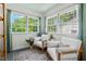 Inviting sunroom with large windows, comfortable seating, and a bright, airy ambiance at 2504 State St, Durham, NC 27704