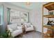 Bright sunroom with two chairs, light-green ceiling, large windows, and stylish decor at 2504 State St, Durham, NC 27704
