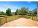 Wooden back deck overlooking an expansive grassy yard with beautiful green landscaping at 2644 Bloomsberry Ridge Dr, Fuquay Varina, NC 27526