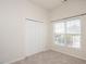 Well-lit bedroom with neutral carpet, closet, and large window with blinds at 2644 Bloomsberry Ridge Dr, Fuquay Varina, NC 27526