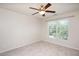 Bedroom featuring a ceiling fan, neutral carpet, and a large window with blinds at 2644 Bloomsberry Ridge Dr, Fuquay Varina, NC 27526