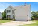 Charming two-story home with white siding, well-manicured lawn, and a two-car garage at 2644 Bloomsberry Ridge Dr, Fuquay Varina, NC 27526