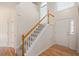 Welcoming foyer with hardwood floors, staircase with white banister, and natural light at 2644 Bloomsberry Ridge Dr, Fuquay Varina, NC 27526