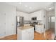 Spacious kitchen featuring white cabinets, granite countertops, stainless steel appliances, and a functional island at 2644 Bloomsberry Ridge Dr, Fuquay Varina, NC 27526