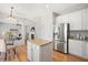 Modern kitchen with stainless steel appliances, granite countertops, and an open layout to the living area at 2644 Bloomsberry Ridge Dr, Fuquay Varina, NC 27526