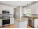 Bright kitchen boasts white cabinetry, stainless steel appliances, and granite countertops at 2644 Bloomsberry Ridge Dr, Fuquay Varina, NC 27526