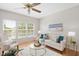 Inviting living room with large windows, a ceiling fan, and comfortable seating at 2644 Bloomsberry Ridge Dr, Fuquay Varina, NC 27526