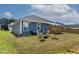 Beautiful backyard with seating area, sun shade, and manicured lawn, perfect for outdoor activities and relaxation at 265 Purple Aster St, Youngsville, NC 27596