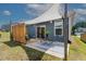 Backyard patio features a sun shade, modern privacy screen, and outdoor dining set, ideal for entertaining guests at 265 Purple Aster St, Youngsville, NC 27596