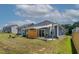Spacious backyard featuring a covered patio, seating area, and lush green lawn, great for outdoor enjoyment at 265 Purple Aster St, Youngsville, NC 27596