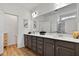 Spacious bathroom featuring wood floors, double sinks, and a glass-enclosed walk-in shower at 265 Purple Aster St, Youngsville, NC 27596