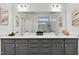 Modern bathroom with double sinks, gray cabinetry, and a large mirror with vanity lighting at 265 Purple Aster St, Youngsville, NC 27596