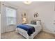 Comfortable bedroom with a plush bed, accent pillows, and a window with natural light at 265 Purple Aster St, Youngsville, NC 27596