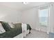 Cozy bedroom featuring a queen bed, soft carpet, and a bright window with sheer curtains at 265 Purple Aster St, Youngsville, NC 27596
