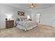 Well-lit bedroom with a queen-sized bed, soft carpet, ceiling fan and stylish decor at 265 Purple Aster St, Youngsville, NC 27596