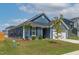 Attractive two-story home with a well-manicured lawn, attached garage, and appealing blue siding at 265 Purple Aster St, Youngsville, NC 27596