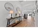 Inviting entryway with hardwood floors, decorative table, stylish lamps, and open view into a living area at 265 Purple Aster St, Youngsville, NC 27596