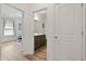 Hallway view of bathroom and office space with great lighting, storage and wood flooring at 265 Purple Aster St, Youngsville, NC 27596