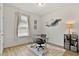 Bright home office featuring a sleek glass desk, stylish decor, and natural light from the window at 265 Purple Aster St, Youngsville, NC 27596