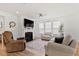 Bright living room featuring a fireplace, recessed lighting and multiple comfortable seating options at 265 Purple Aster St, Youngsville, NC 27596