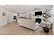 Open floor plan with a living room and kitchen featuring hardwood floors and white cabinetry at 265 Purple Aster St, Youngsville, NC 27596
