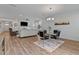 Spacious open-concept living space with dining area, modern chandelier, and view of the living room at 265 Purple Aster St, Youngsville, NC 27596
