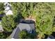 Aerial view showcases the home's location, surrounded by trees and a well-manicured lawn at 3 Waconda Ct, Durham, NC 27713