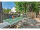 Spacious backyard with a playground, garden boxes, privacy fence, and mature trees at 3 Waconda Ct, Durham, NC 27713