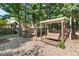 A backyard featuring a swing, garden, and playground, perfect for outdoor living and entertaining at 3 Waconda Ct, Durham, NC 27713