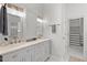 Bathroom features a double vanity, walk-in shower, and access to the closet at 3 Waconda Ct, Durham, NC 27713