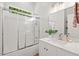 Bright bathroom featuring a shower-tub combo, single sink vanity, and a framed mirror at 3 Waconda Ct, Durham, NC 27713