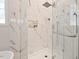 Bathroom features a glass walk-in shower with marble tile and a built-in niche at 3 Waconda Ct, Durham, NC 27713