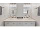 Bathroom boasts a double vanity with a marble countertop and modern lighting fixtures at 3 Waconda Ct, Durham, NC 27713