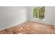 A vacant bedroom with neutral walls, wood floors, and a large window, ready for customization at 3 Waconda Ct, Durham, NC 27713