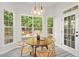 Light-filled breakfast nook surrounded by windows, a round table, and outdoor views at 3 Waconda Ct, Durham, NC 27713