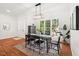 Open dining room with hardwood flooring, lots of sunlight, and an adjacent entryway at 3 Waconda Ct, Durham, NC 27713