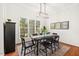 Elegant dining room with ample natural light, a stylish chandelier, and room for a full table set at 3 Waconda Ct, Durham, NC 27713
