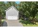 Charming home exterior with a well-maintained lawn, mature trees, and a spacious driveway at 3 Waconda Ct, Durham, NC 27713