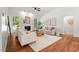 Cozy living room with a fireplace, hardwood floors, neutral furniture, and many windows at 3 Waconda Ct, Durham, NC 27713