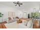 Bright, open-concept living room features hardwood floors, a modern ceiling fan, and a neutral color palette at 3 Waconda Ct, Durham, NC 27713