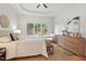 Main bedroom boasts a tray ceiling, hardwood floors, and a window overlooking the backyard at 3 Waconda Ct, Durham, NC 27713