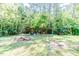Spacious backyard with a wooden structure, perfect for outdoor activities and storage at 3564 Lower Moncure Rd, Sanford, NC 27330