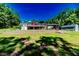 Expansive backyard featuring a deck, shed, and lush greenery, perfect for outdoor enjoyment and entertaining at 3564 Lower Moncure Rd, Sanford, NC 27330