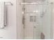 Modern bathroom shower with white tile, glass door, and dual shower heads at 3564 Lower Moncure Rd, Sanford, NC 27330