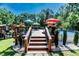 Outdoor deck with pool and seating areas surrounded by lush greenery at 3564 Lower Moncure Rd, Sanford, NC 27330