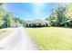 Spacious home with lush green lawn, outbuilding, and long driveway at 3564 Lower Moncure Rd, Sanford, NC 27330